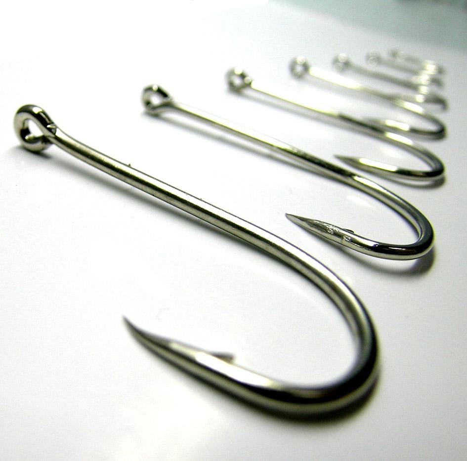 Conjunto de anzóis de pesca sobre superfície branca